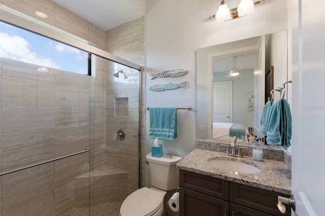 ensuite bathroom featuring toilet, ensuite bath, a shower stall, and vanity