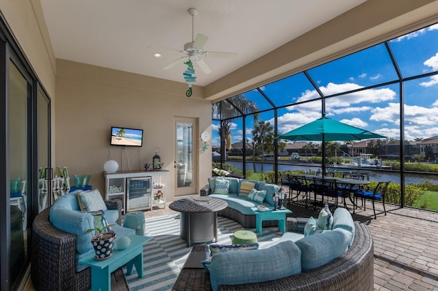 view of patio / terrace featuring glass enclosure, ceiling fan, and outdoor lounge area