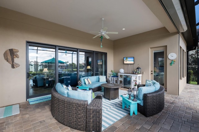 view of patio / terrace featuring a ceiling fan, wine cooler, and an outdoor hangout area