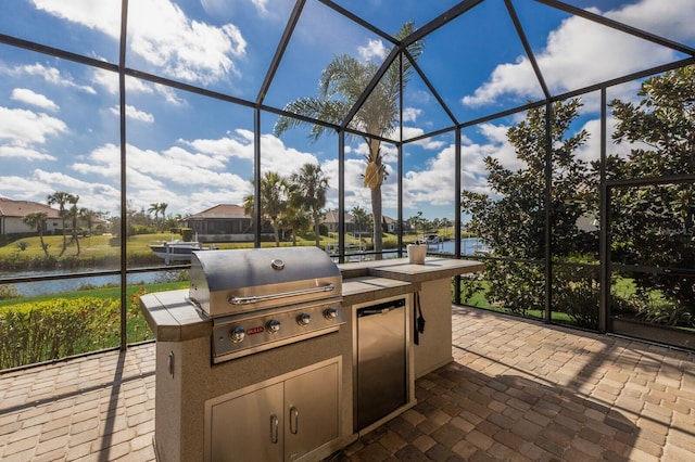 view of patio / terrace with a lanai and grilling area