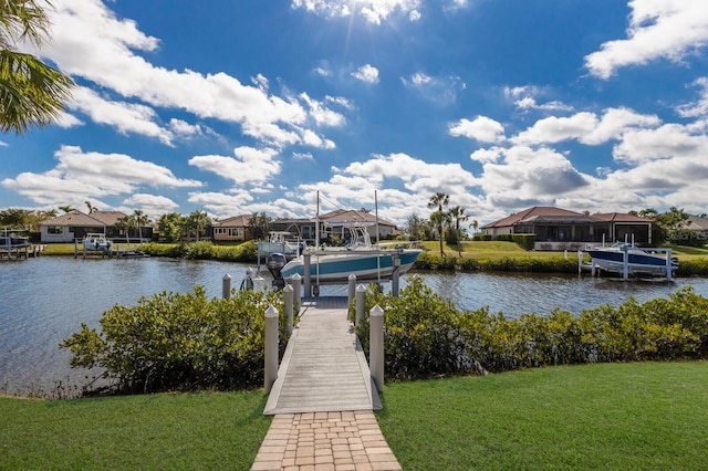 dock area featuring a lawn, a water view, and boat lift