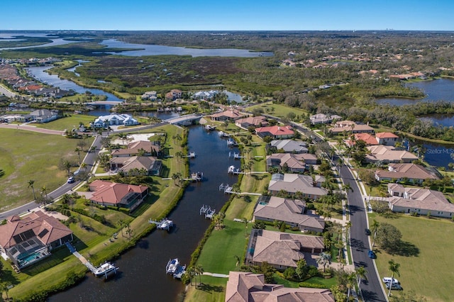 birds eye view of property with a residential view and a water view