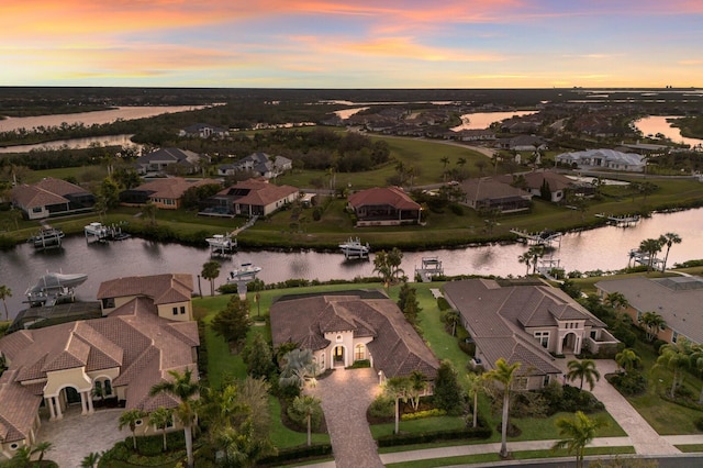 drone / aerial view with a water view and a residential view