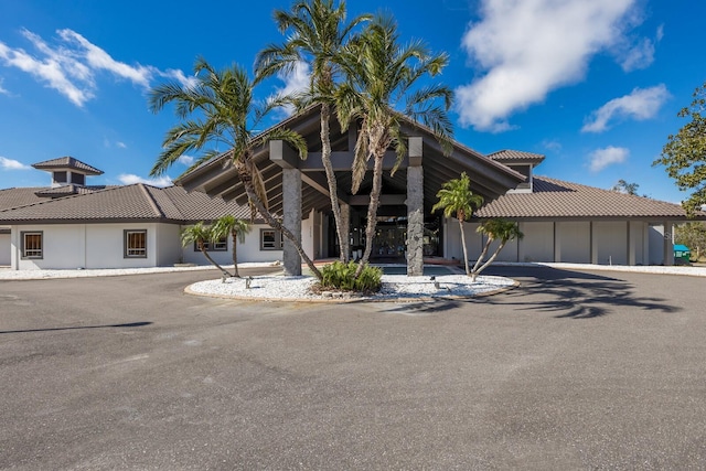 view of front of property featuring a tiled roof and stucco siding