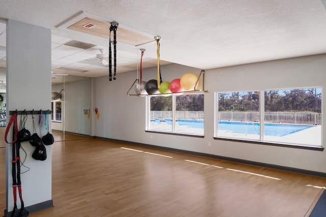 view of basketball court with fence and a fenced in pool