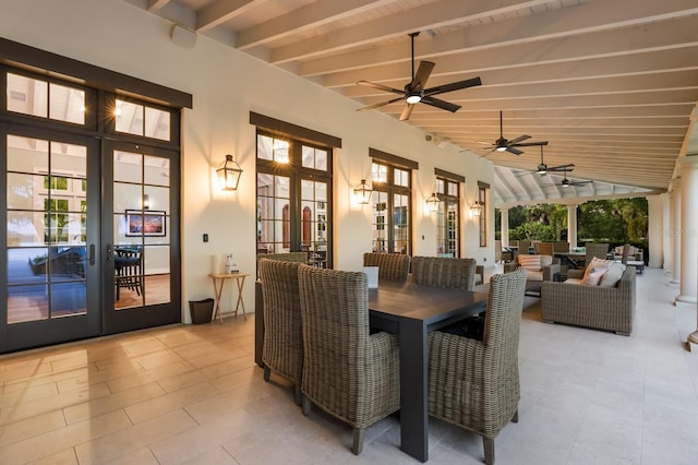 view of patio / terrace featuring a ceiling fan, outdoor dining space, and french doors