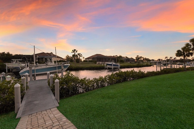 11739 River Shores Trl, Parrish, FL 34219 - yard at dusk with boat lift, a lawn, a water view, and a boat dock