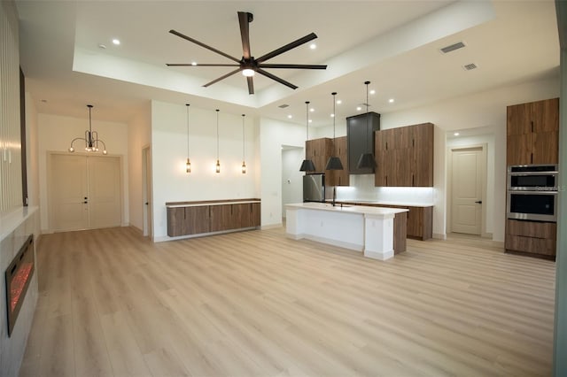 kitchen featuring light wood-style floors, visible vents, stainless steel appliances, and light countertops