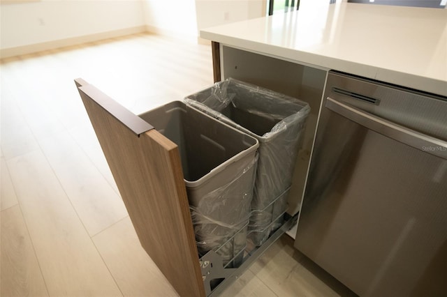 details featuring light countertops, stainless steel dishwasher, and light wood-type flooring