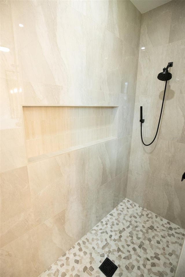 full bath with a tile shower