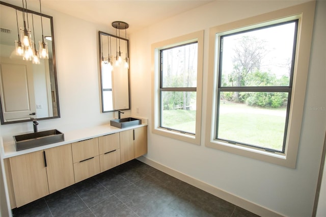 full bathroom featuring double vanity, a sink, visible vents, and baseboards