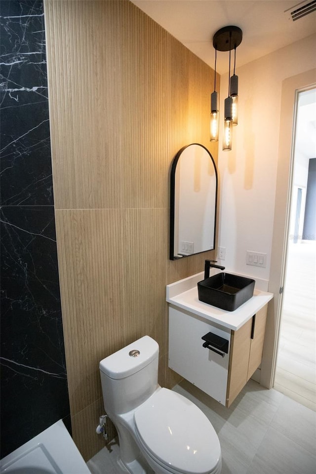 bathroom featuring visible vents, vanity, and toilet