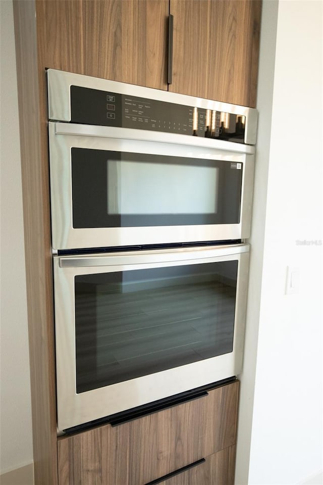 details featuring double oven, modern cabinets, and brown cabinetry