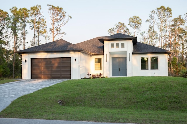 view of front facade with decorative driveway, roof with shingles, stucco siding, an attached garage, and a front lawn