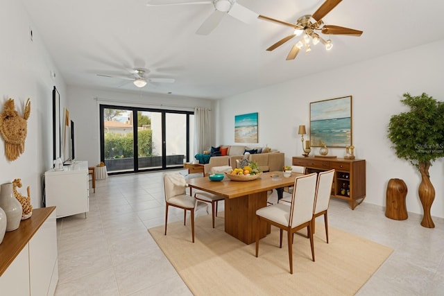 dining space featuring ceiling fan and light tile patterned flooring