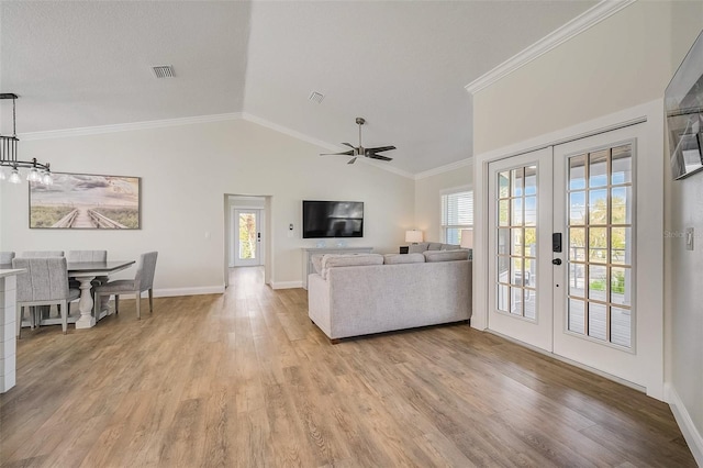 living room featuring ornamental molding, french doors, plenty of natural light, and visible vents