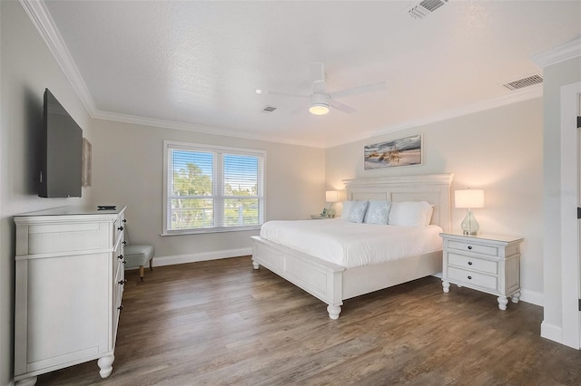 bedroom with ornamental molding, dark wood-style flooring, and visible vents