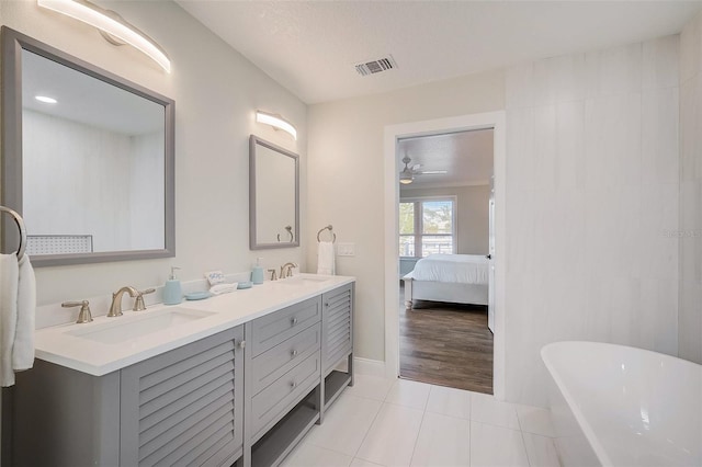 full bath featuring double vanity, tile patterned flooring, a sink, and visible vents