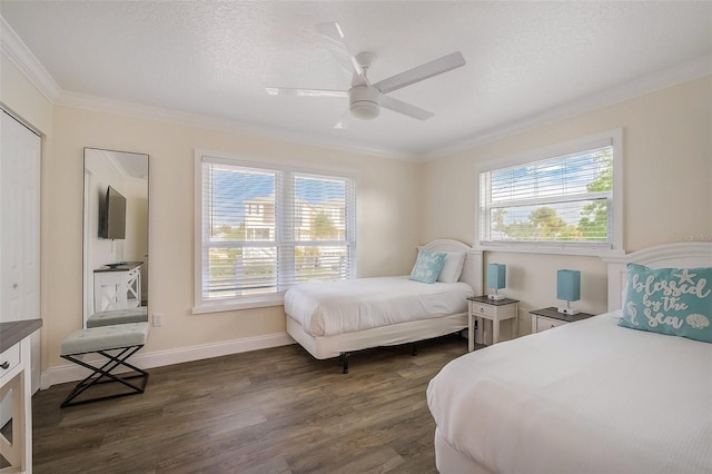 bedroom with a textured ceiling, multiple windows, dark wood finished floors, and crown molding