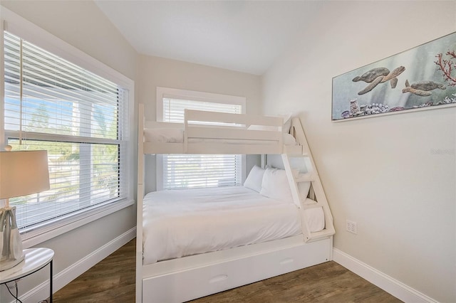 bedroom featuring wood finished floors and baseboards