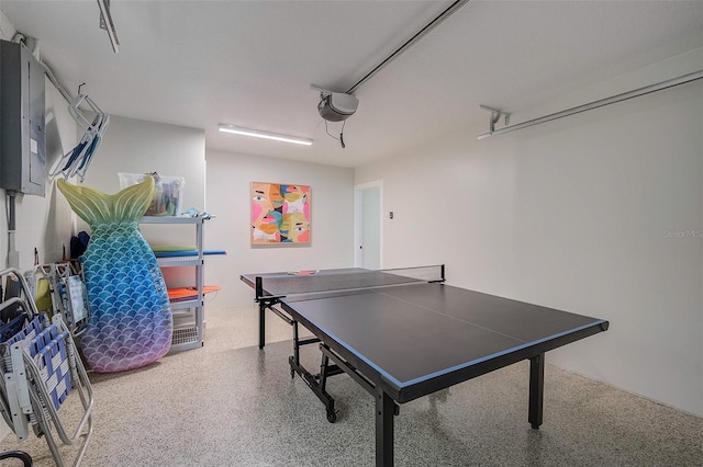 game room featuring a garage and speckled floor