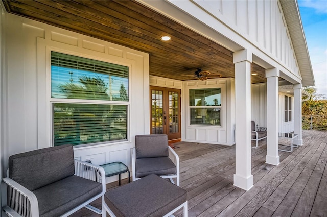 wooden deck with a ceiling fan and french doors