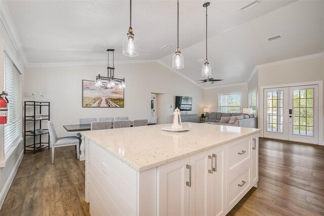 kitchen with lofted ceiling, visible vents, dark wood finished floors, and a center island