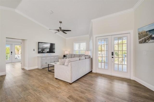 living area featuring french doors, visible vents, crown molding, and wood finished floors