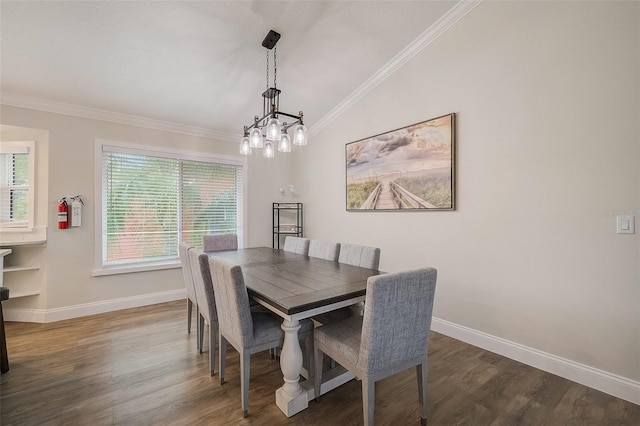 dining room featuring baseboards, dark wood finished floors, and crown molding