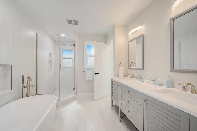 full bathroom featuring a freestanding tub, a sink, a shower stall, and double vanity