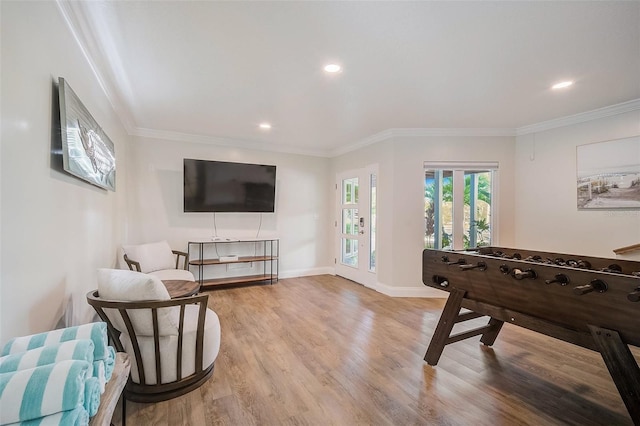 game room featuring light wood-type flooring, baseboards, ornamental molding, and recessed lighting