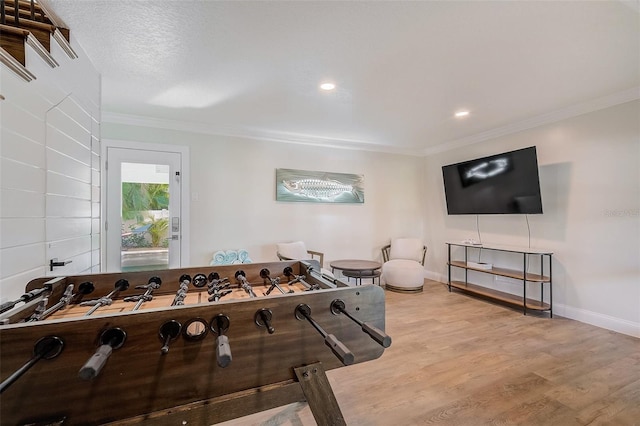 rec room with ornamental molding, recessed lighting, baseboards, and wood finished floors