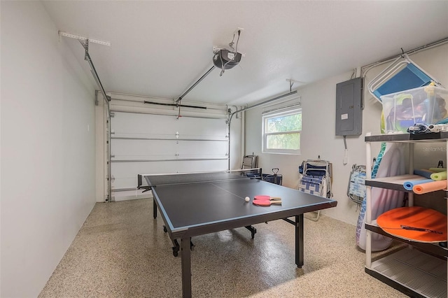 rec room featuring light speckled floor, electric panel, and a garage