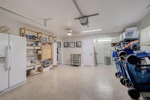 garage with white fridge with ice dispenser and a garage door opener