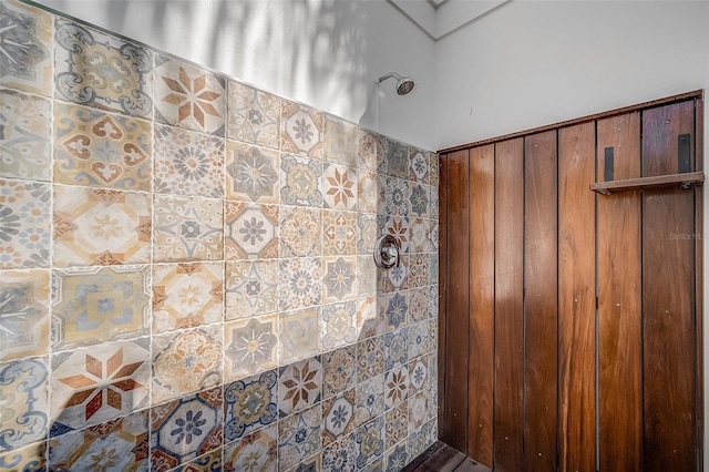 full bathroom featuring a skylight and a tile shower