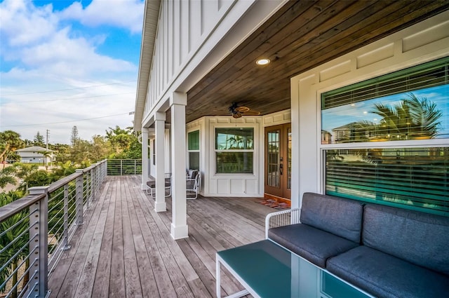 wooden terrace featuring ceiling fan and an outdoor hangout area