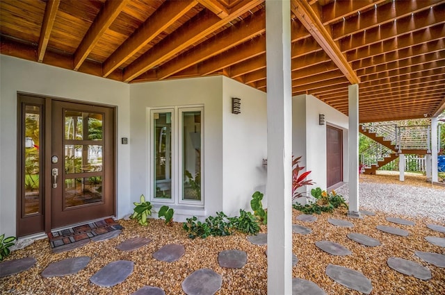 property entrance with stucco siding