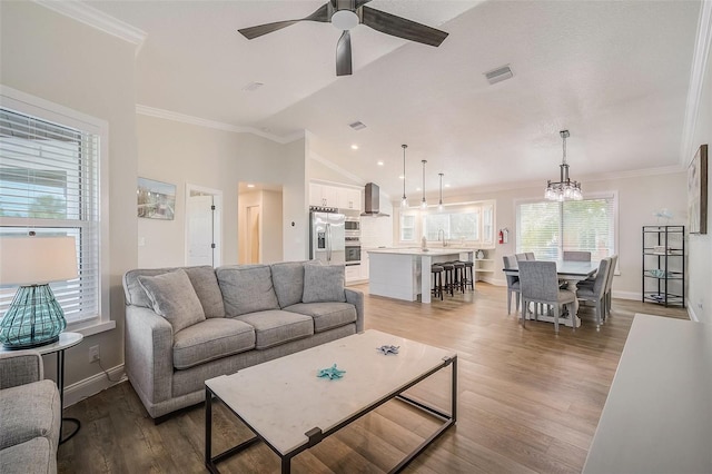 5708 Holmes Blvd, Holmes Beach, FL 34217 - living room with a ceiling fan, light wood-style floors, a chandelier, lofted ceiling, and baseboards