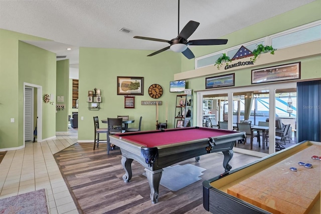 playroom with a textured ceiling, a high ceiling, billiards, visible vents, and tile patterned floors