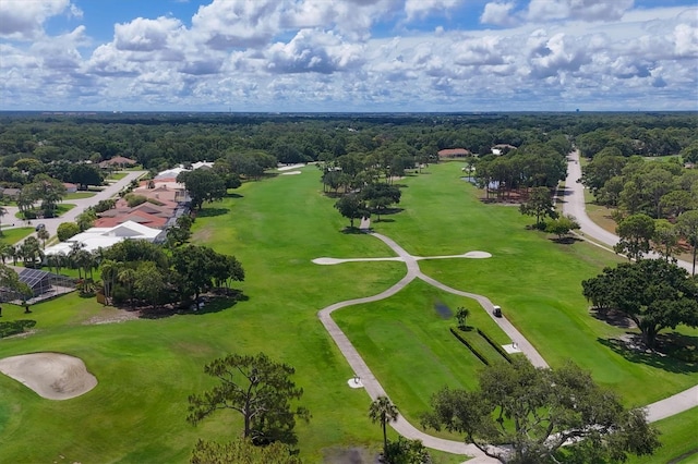 aerial view with view of golf course and a view of trees