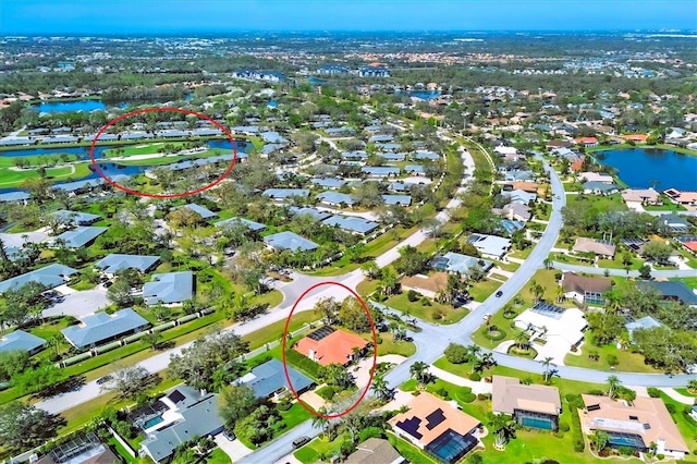 bird's eye view featuring a water view and a residential view