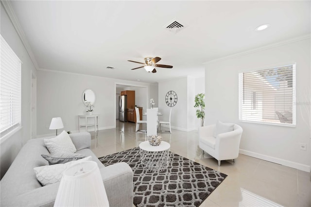 tiled living room with ceiling fan, ornamental molding, visible vents, and baseboards