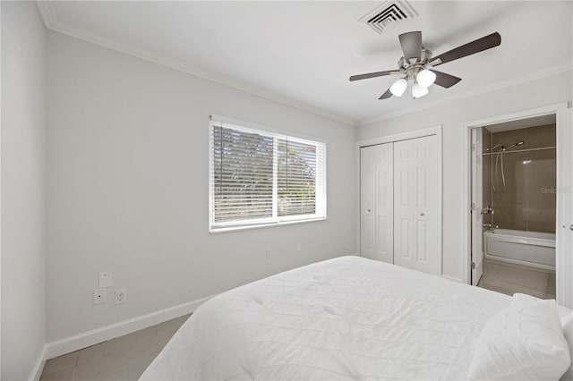 bedroom with baseboards, visible vents, connected bathroom, crown molding, and a closet