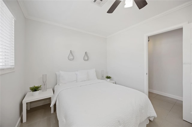 tiled bedroom with baseboards, a ceiling fan, visible vents, and crown molding