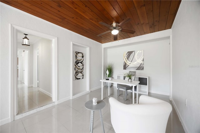 tiled dining room featuring a ceiling fan, wooden ceiling, and baseboards