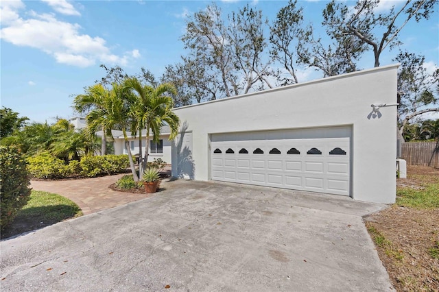 view of front of home with driveway, a garage, and stucco siding