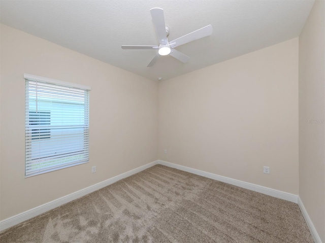 unfurnished room with light carpet, ceiling fan, and baseboards