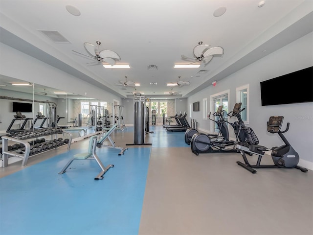 workout area featuring visible vents, plenty of natural light, and ceiling fan