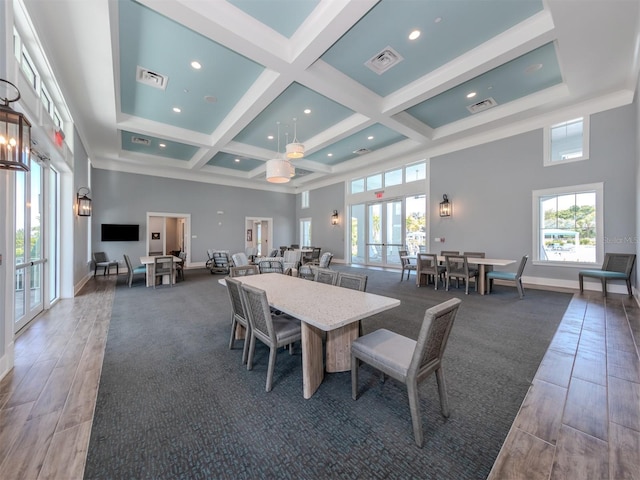 dining space with coffered ceiling, french doors, visible vents, and a towering ceiling