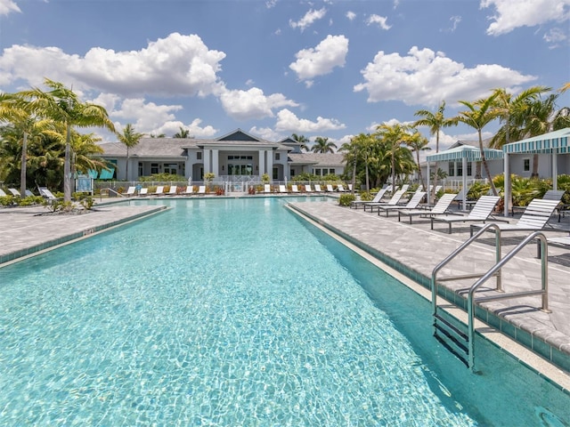 pool with fence and a patio